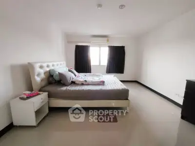 Spacious bedroom with modern decor and natural light
