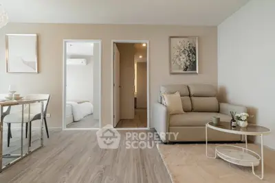 Modern living room with elegant decor and open layout, featuring cozy seating and stylish dining area.