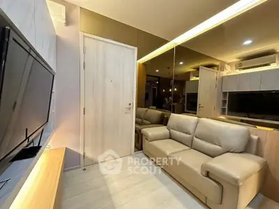 Modern living room with sleek design, leather sofa, and wall-mounted TV in a cozy apartment.