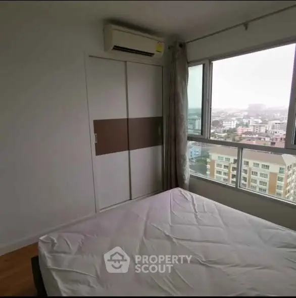 Spacious bedroom with city view and large window