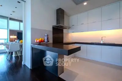 Modern kitchen with sleek design and open layout, featuring a stylish breakfast bar and ample storage.