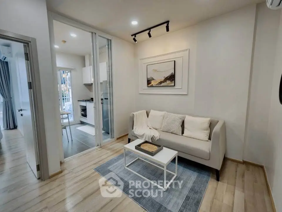 Modern living room with cozy sofa and stylish decor in open layout apartment.