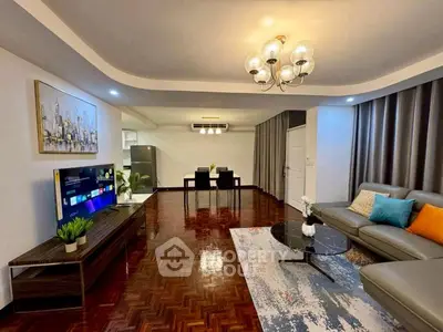 Spacious living room with modern decor and open layout, featuring stylish furniture and elegant lighting.