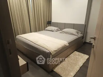Cozy modern bedroom with elegant decor and plush bedding in a stylish apartment.