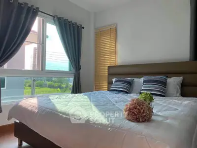 Bright and cozy bedroom with large window and stylish decor