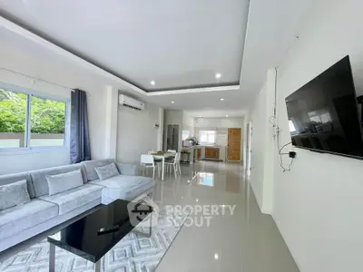 Spacious modern living room with open kitchen and sleek furnishings