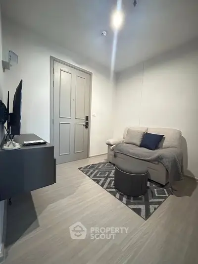 Cozy living room with modern decor and comfortable seating in a stylish apartment.
