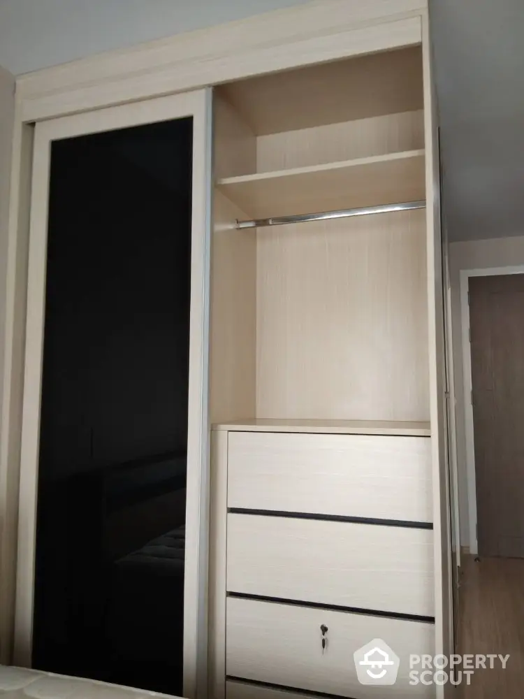 Modern built-in wardrobe with sliding doors and ample storage space