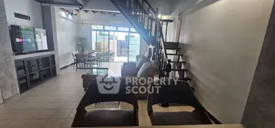 Spacious living room with modern decor and mezzanine, perfect for family gatherings.