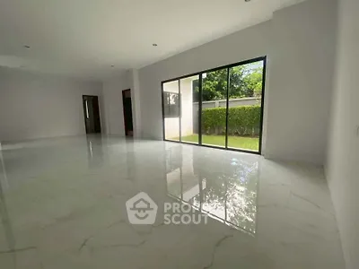 Spacious modern living room with large windows and garden view