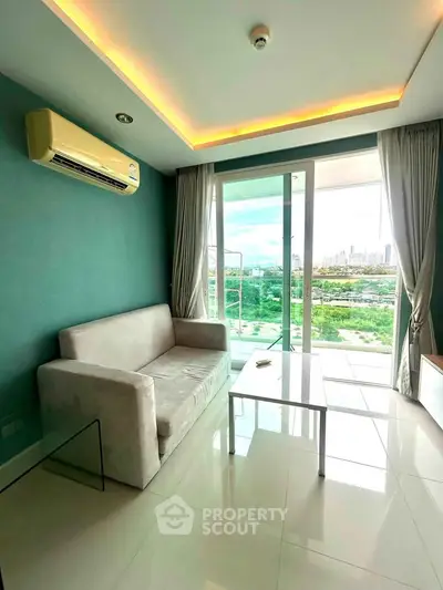 Modern living room with large windows and city view, featuring a cozy sofa and sleek design.