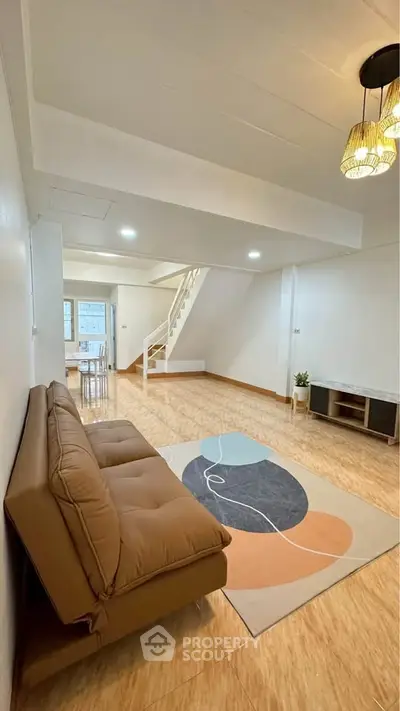 Spacious living room with modern decor and stylish lighting