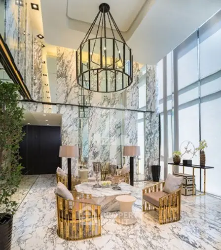 Luxurious modern living room with marble walls and floor, elegant chandelier, and stylish furniture.