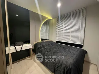 Modern bedroom with stylish lighting and sleek furnishings