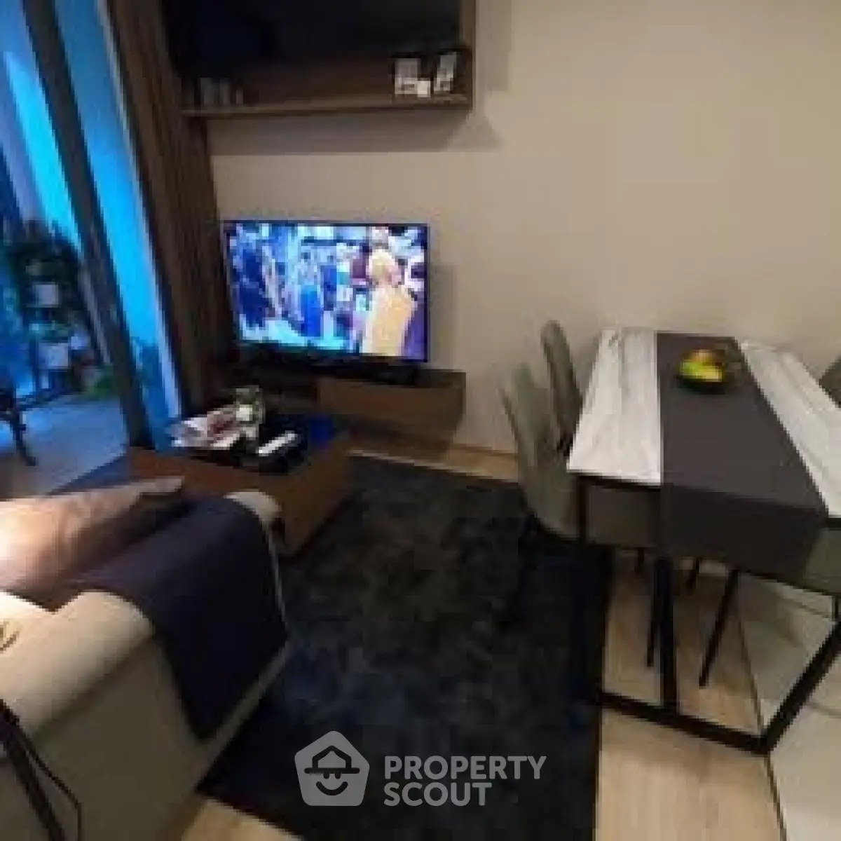 Cozy living room with modern decor and dining area, perfect for relaxation and entertainment.