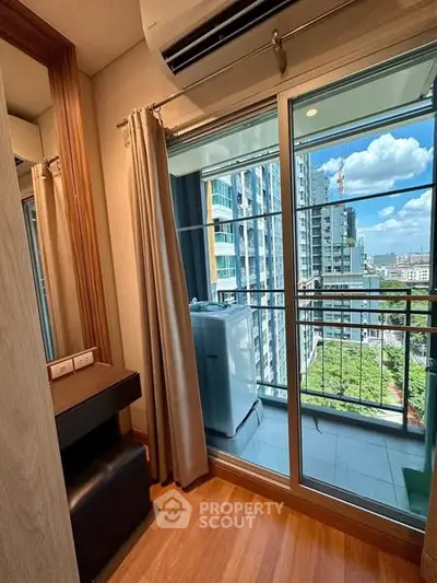 Modern condo balcony with city view and washing machine, perfect for urban living.