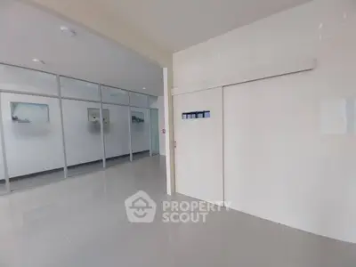 Modern office entrance with sleek glass partitions and minimalist design