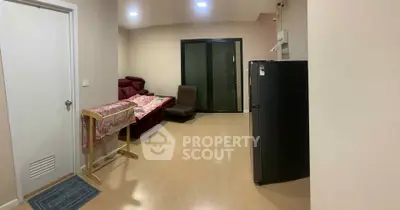 Spacious living room with modern furniture and sleek flooring, perfect for relaxation and entertainment.