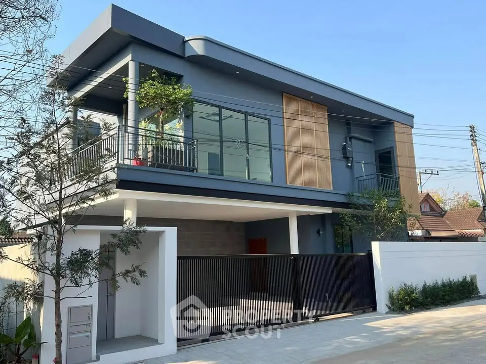 Modern two-story house with sleek design and spacious balcony in a serene neighborhood.