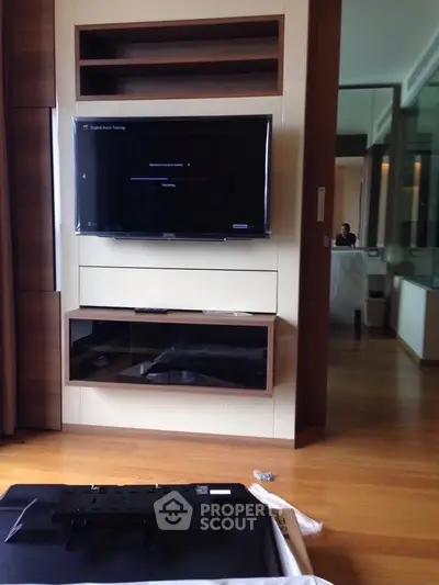 Modern living room with wall-mounted TV and wooden flooring