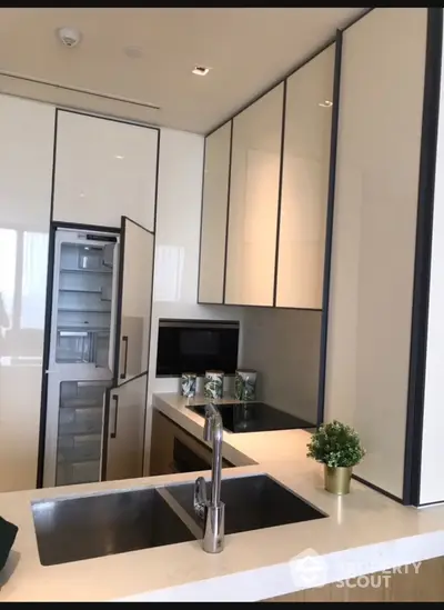 Modern kitchen with sleek cabinetry and built-in appliances in luxury apartment