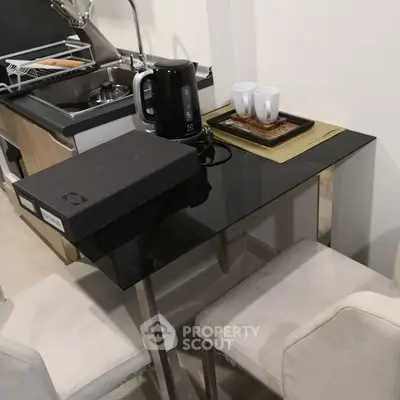 Compact kitchen corner with sleek black table and modern appliances