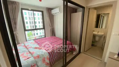 Cozy bedroom with large window and ensuite bathroom in modern apartment
