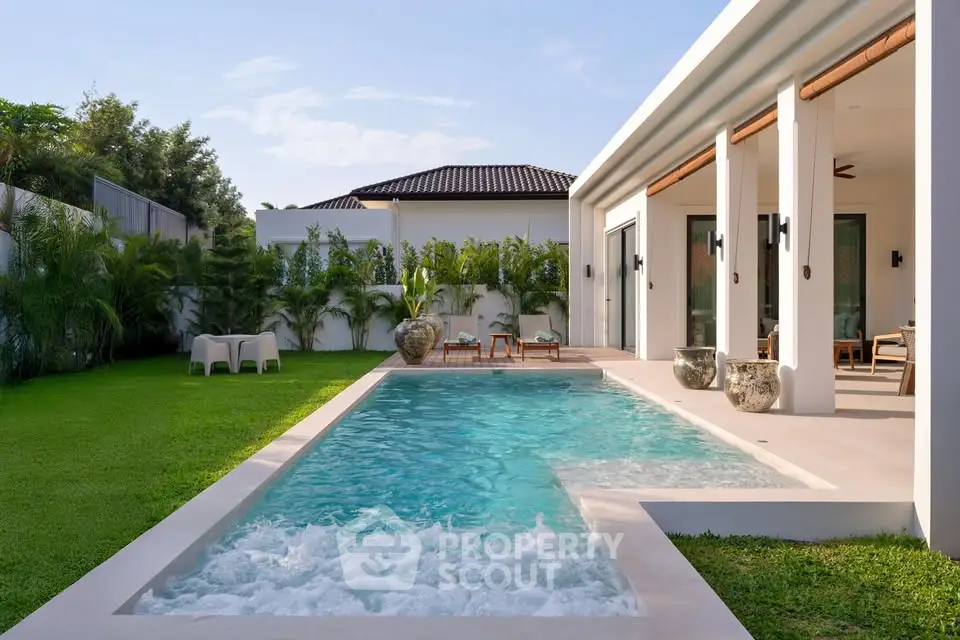 Luxurious modern villa with private pool and lush garden, perfect for relaxation and entertainment.