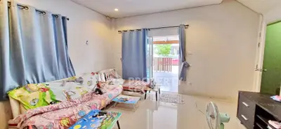 Charming living room with cozy seating and natural light, perfect for relaxation and family gatherings.