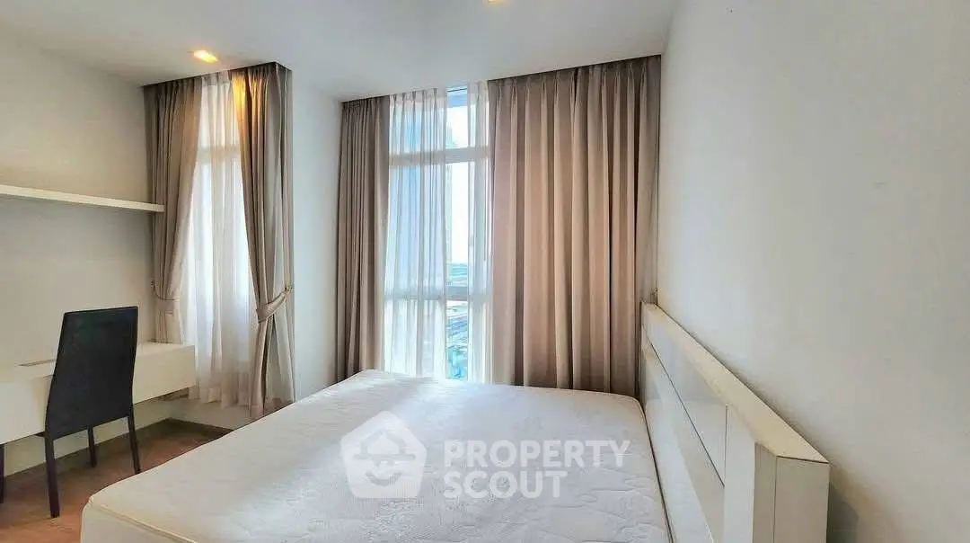 Bright modern bedroom with large windows and elegant curtains