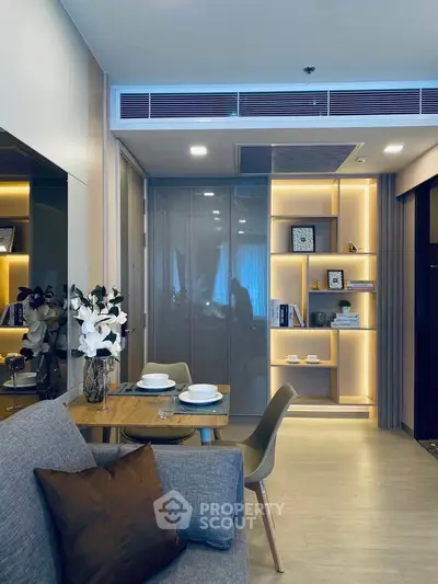 Modern living room with elegant decor and ambient lighting, featuring a cozy dining area and stylish shelving.