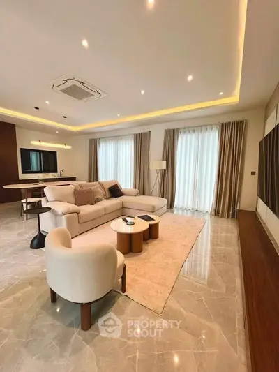 Luxurious living room with elegant furniture and ambient lighting, featuring a spacious open layout and modern design.