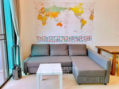 Modern living room with gray sectional sofa and world map wall art