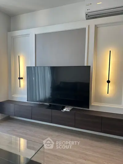 Modern living room with sleek TV setup and stylish wall lighting