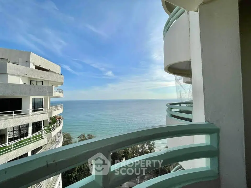 Stunning ocean view from a modern balcony in a high-rise building.