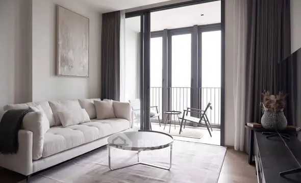 Modern living room with elegant decor and balcony access, featuring stylish furniture and natural light.