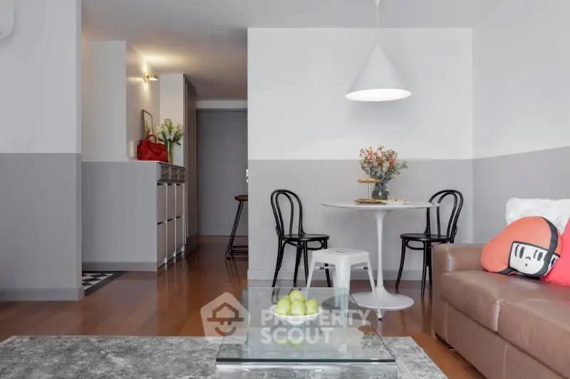 Modern living room with stylish decor and open layout, featuring a cozy seating area and contemporary lighting.