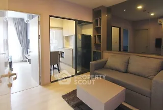 Modern living room with open kitchen and stylish decor in a cozy apartment.