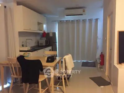 Modern kitchen and dining area with sleek design and neutral tones.