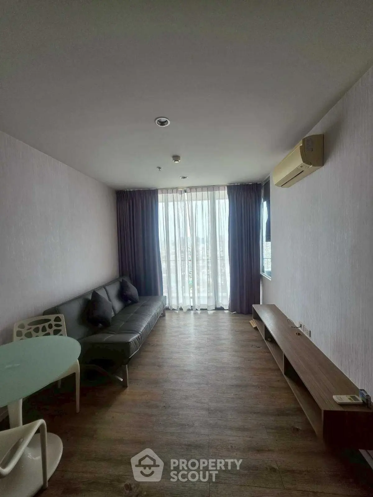 Spacious living room with modern furniture and large window view