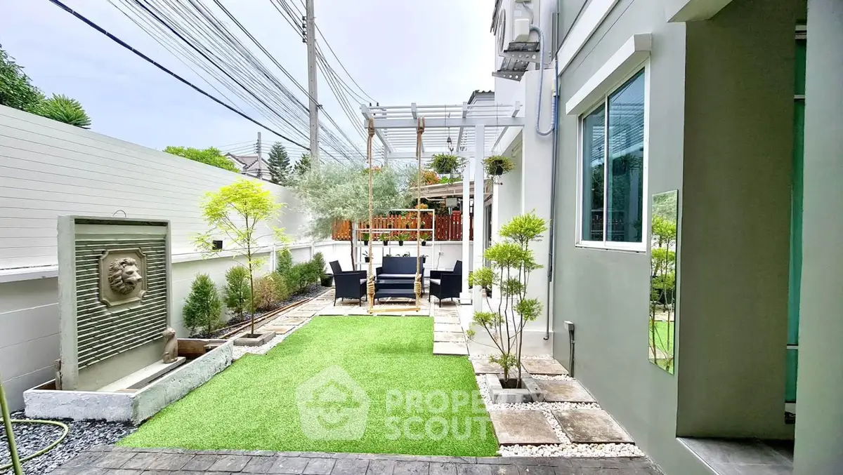 Charming garden with modern landscaping and cozy seating area in a stylish residential property.