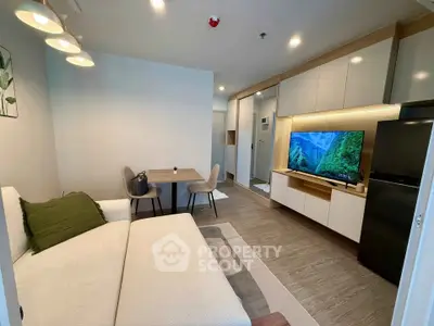 Modern living room with sleek furniture and large TV, perfect for relaxation and entertainment.