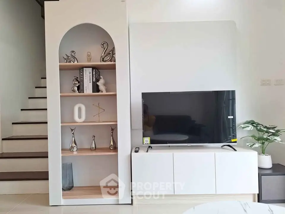 Modern living room with stylish TV unit and decorative shelving