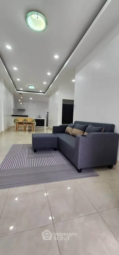 Modern open-plan living room with sleek furniture and stylish lighting