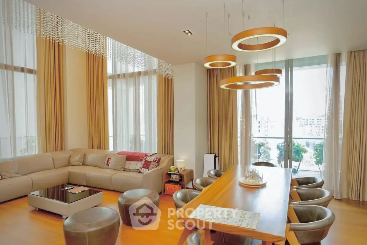 Luxurious modern living room with elegant lighting and large windows offering stunning views.