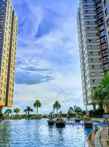 Luxurious high-rise apartment complex with stunning pool and skyline views.