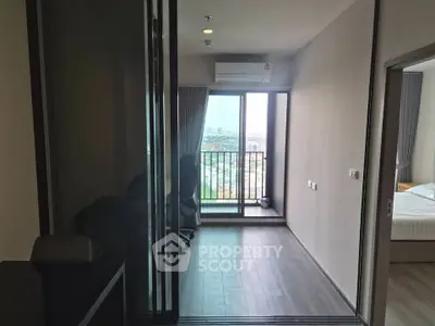 Modern apartment with balcony and city view, featuring sleek interior design and ample natural light.
