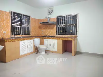 Spacious kitchen with unique tile design and built-in stove