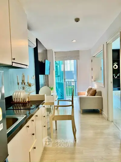 Modern open-layout kitchen and living area with natural light and stylish decor