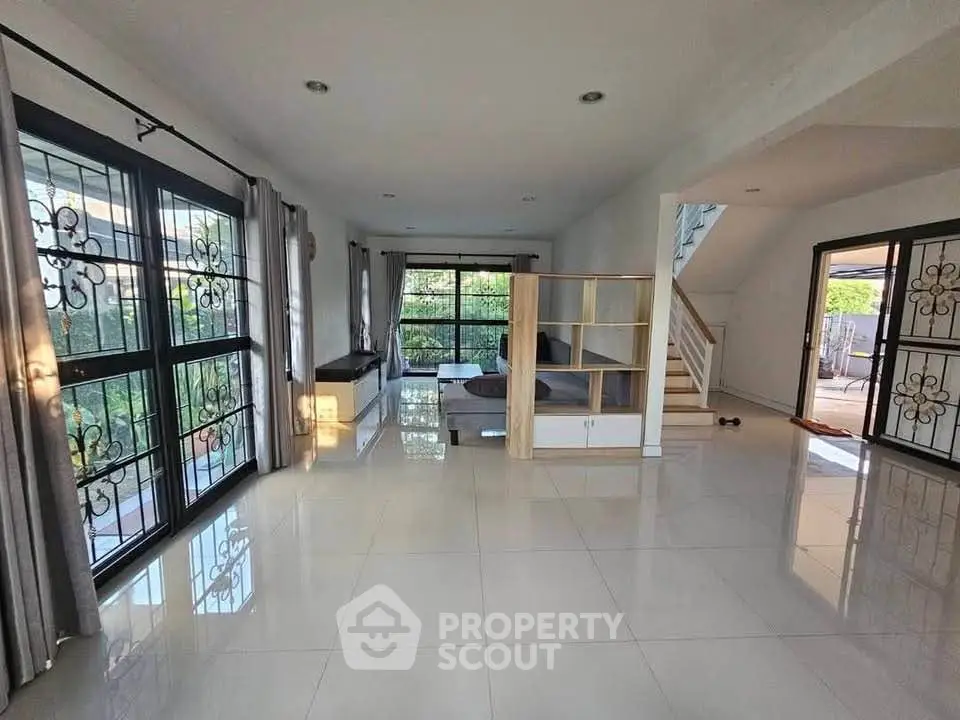 Spacious living room with large windows and modern decor